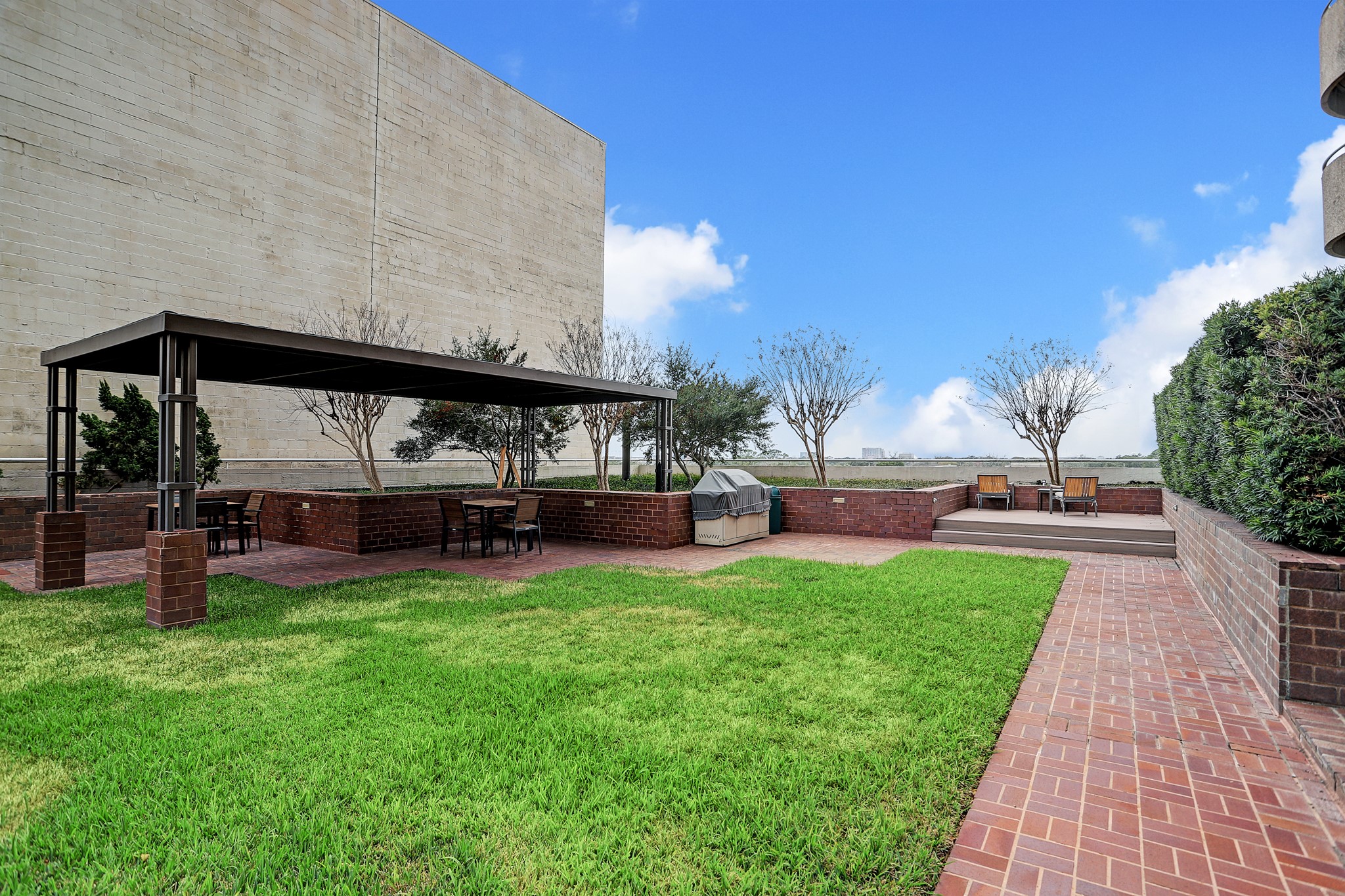 5000 Montrose Boulevard, Unit 18A Houston, TX 77006 - Photo 13 of 14 a view of backyard with swimming pool seating and green space