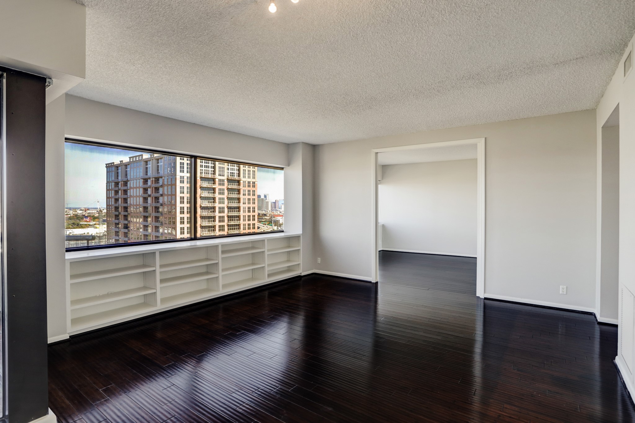 5000 Montrose Boulevard, Unit 18A Houston, TX 77006 - Photo 3 of 14 wooden floor in an empty room with a window
