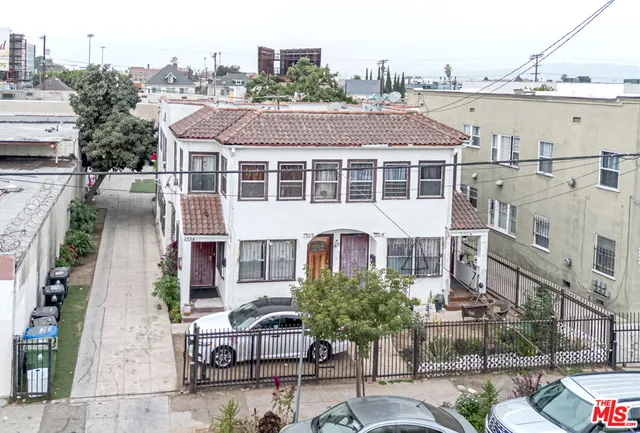 a front view of a residential apartment building with a yard