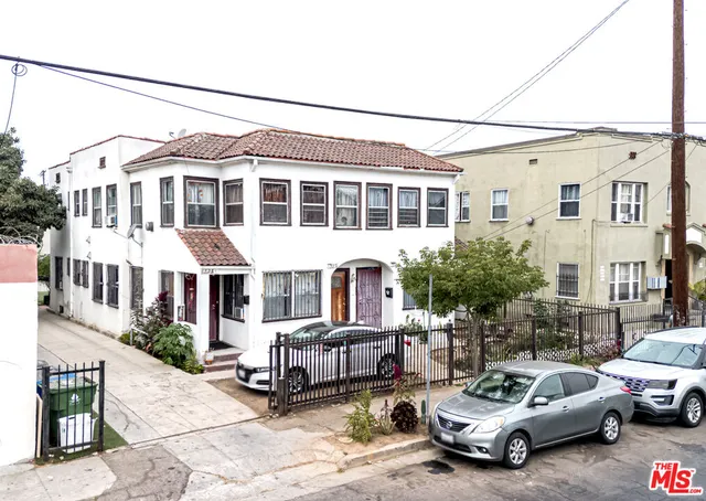 a view of a white car parked in front of a building