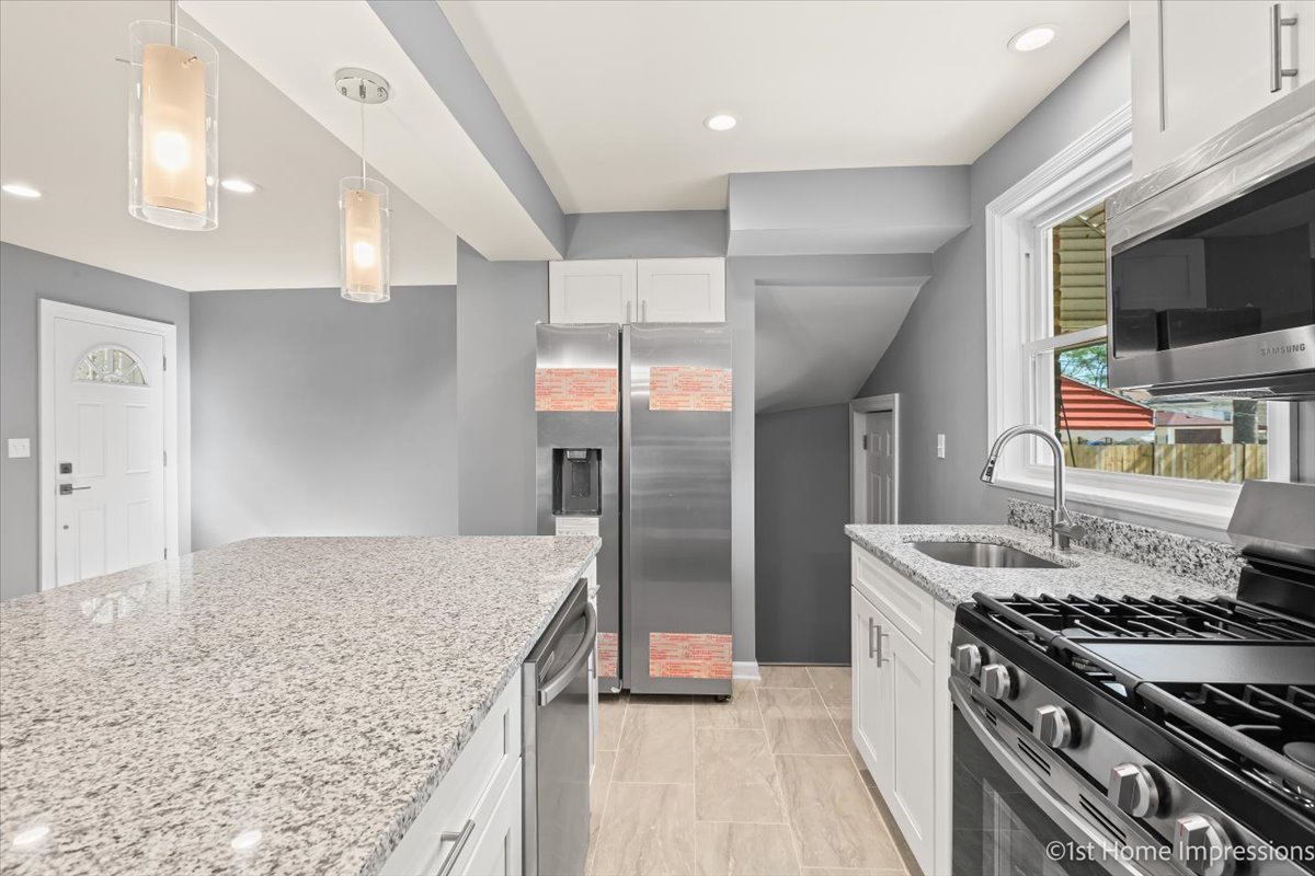 10005 South Sangamon Street Chicago, IL 60643 - Photo 12 of 30 a kitchen with stainless steel appliances granite countertop a stove and a sink