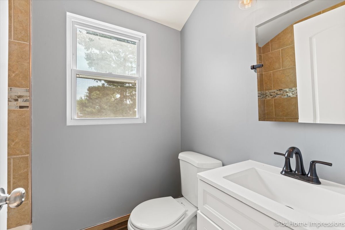 10005 South Sangamon Street Chicago, IL 60643 - Photo 17 of 30 a bathroom with a toilet sink vanity and mirror