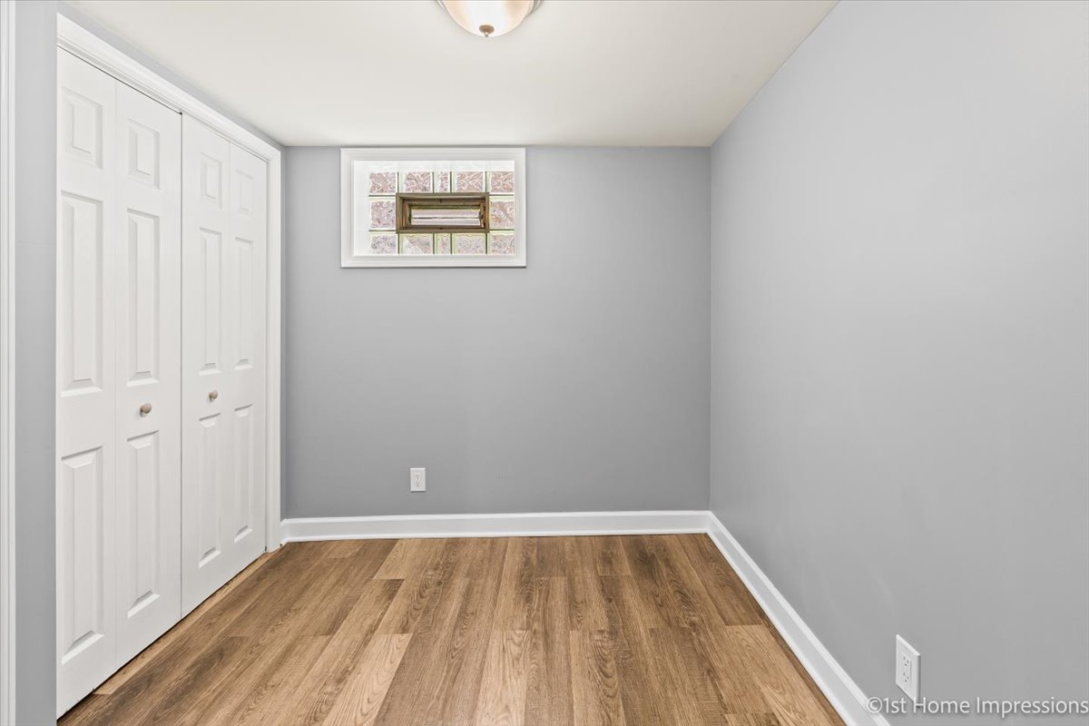 10005 South Sangamon Street Chicago, IL 60643 - Photo 21 of 30 a view of an empty room with wooden floor and a window