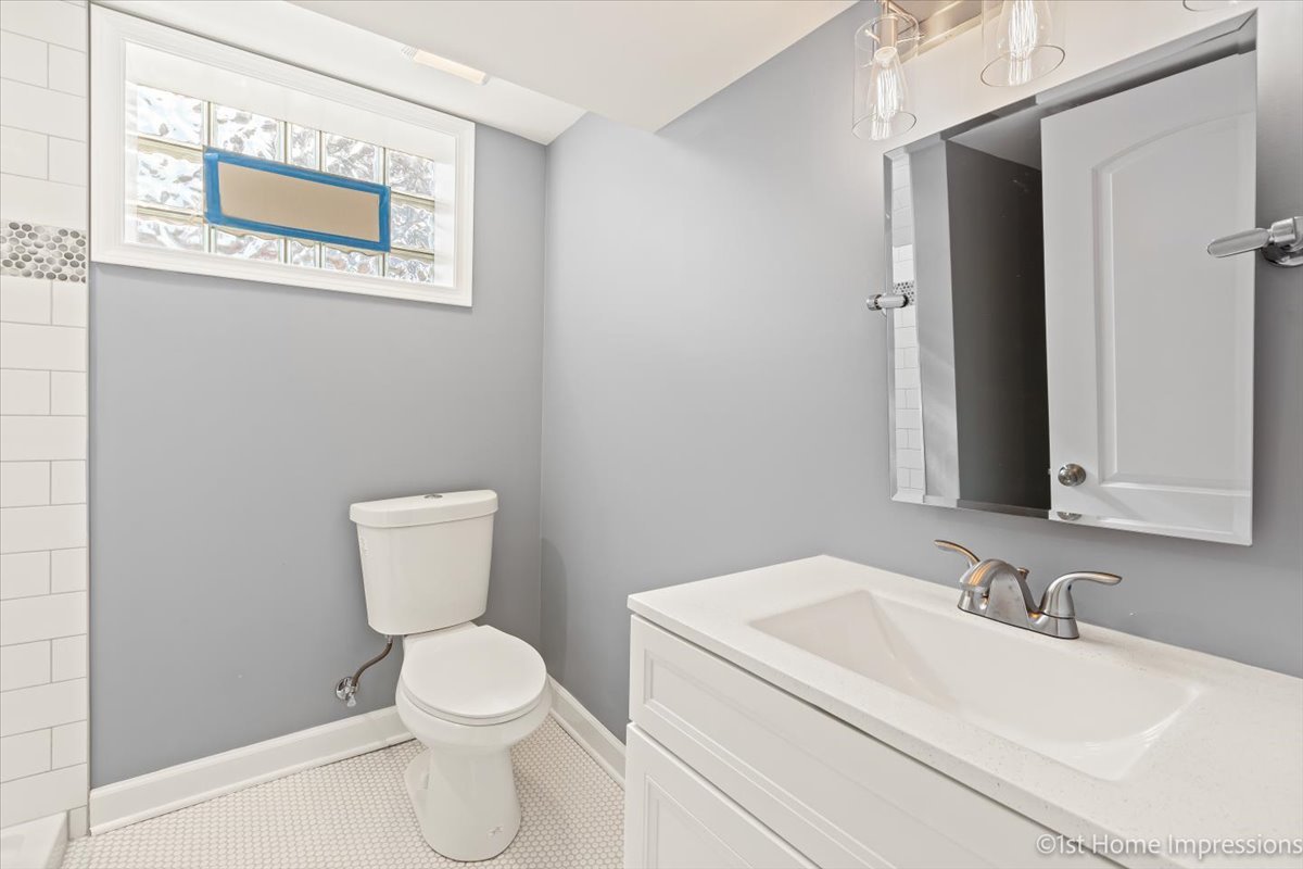 10005 South Sangamon Street Chicago, IL 60643 - Photo 22 of 30 a bathroom with a toilet a sink and mirror