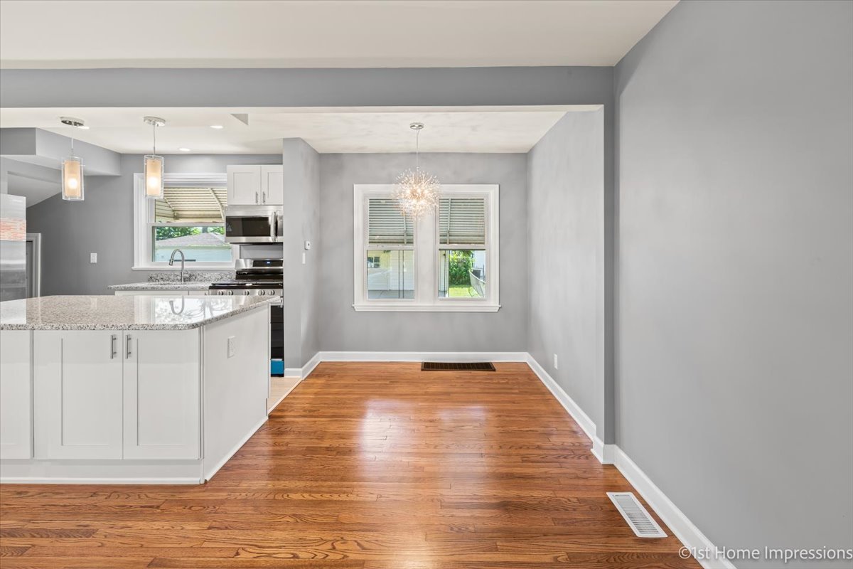 10005 South Sangamon Street Chicago, IL 60643 - Photo 9 of 30 a view of a kitchen with kitchen island a sink wooden floor and a window