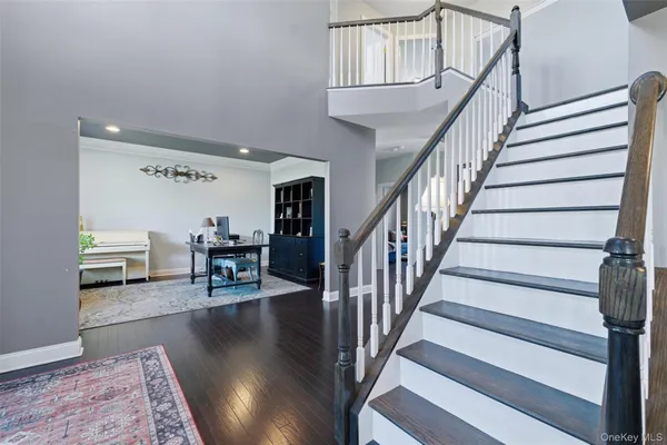a view of a dining room with furniture a chandelier and wooden floor