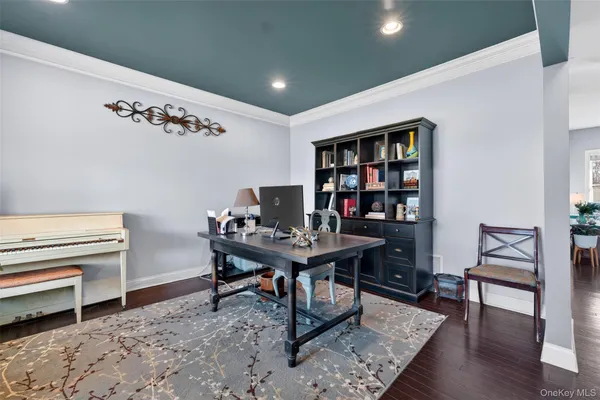 a view of a workspace with furniture and a window