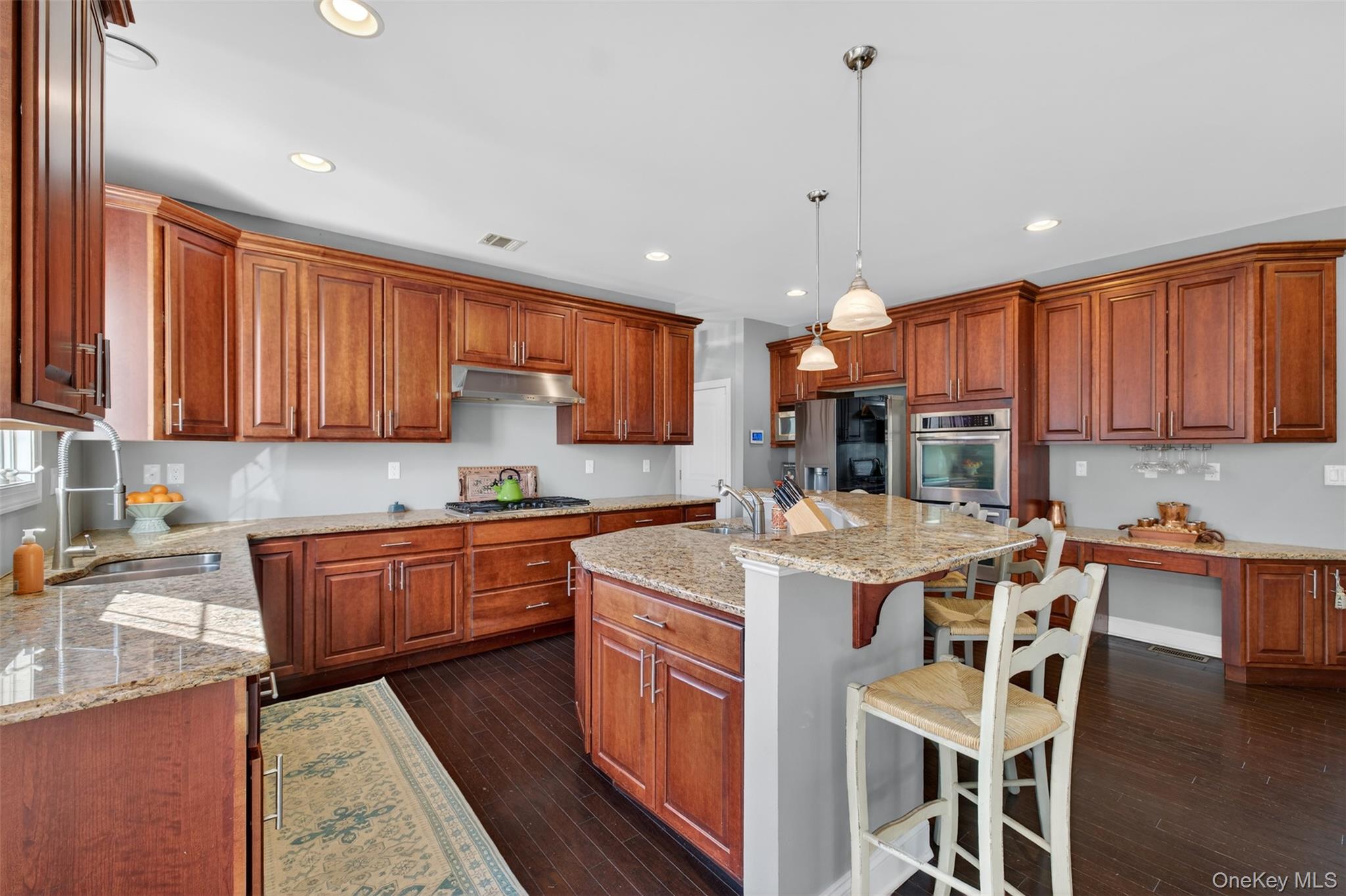 102 Luthien Forrest Road Rock Tavern, NY 12575 - Photo 24 of 45 a kitchen with stainless steel appliances granite countertop wooden cabinets a stove a sink and a refrigerator
