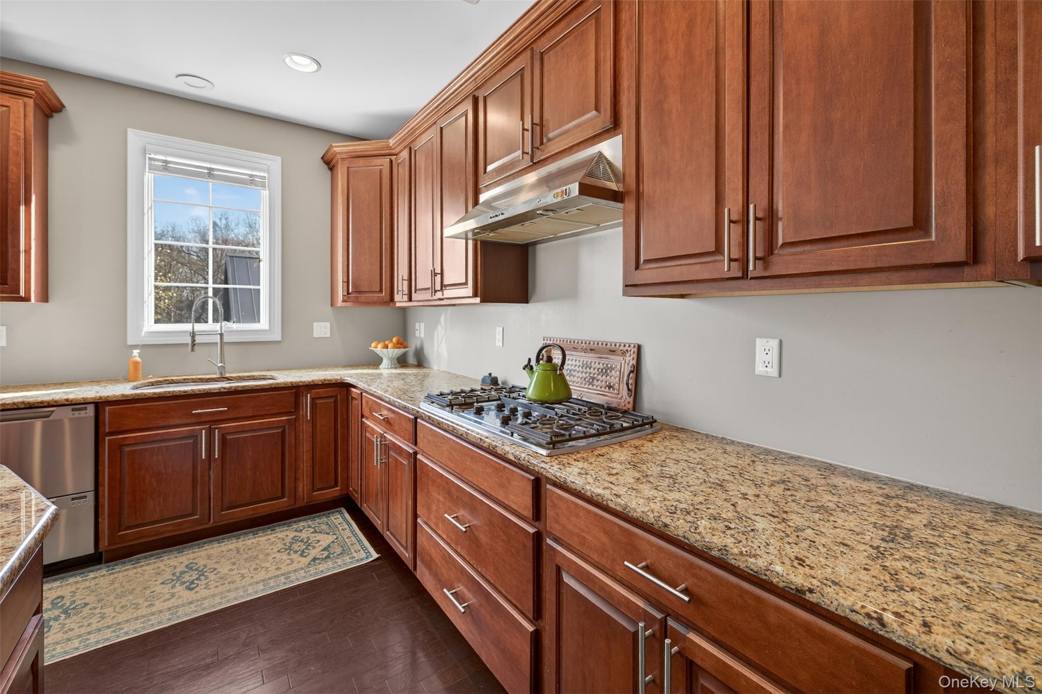 102 Luthien Forrest Road Rock Tavern, NY 12575 - Photo 28 of 45 a kitchen with stainless steel appliances granite countertop wooden cabinets a stove top oven a sink and dishwasher