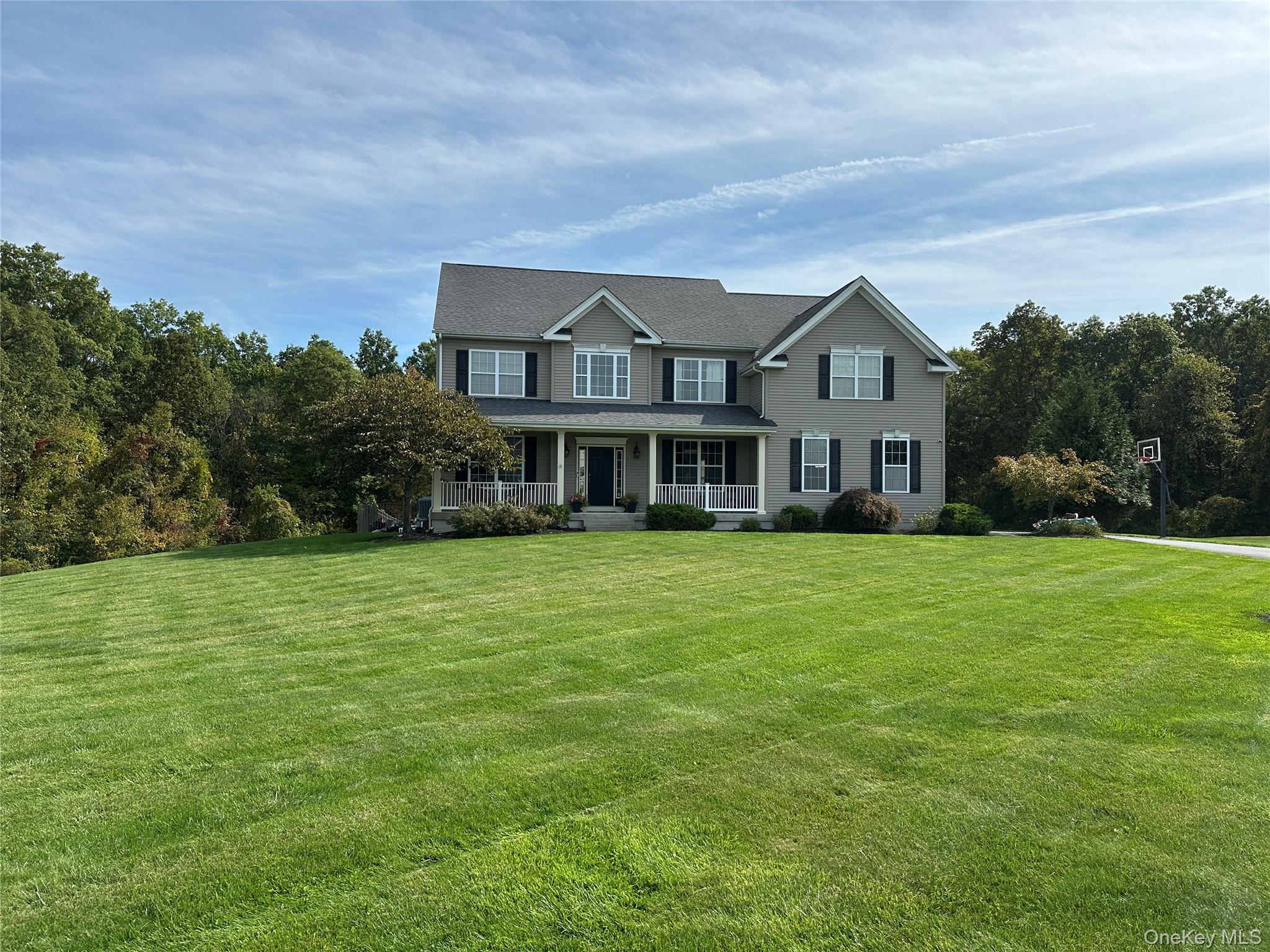 102 Luthien Forrest Road Rock Tavern, NY 12575 - Photo 3 of 6 Colonial-style house with covered porch and a front yard