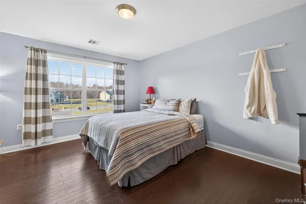a bedroom with a bed window and couch