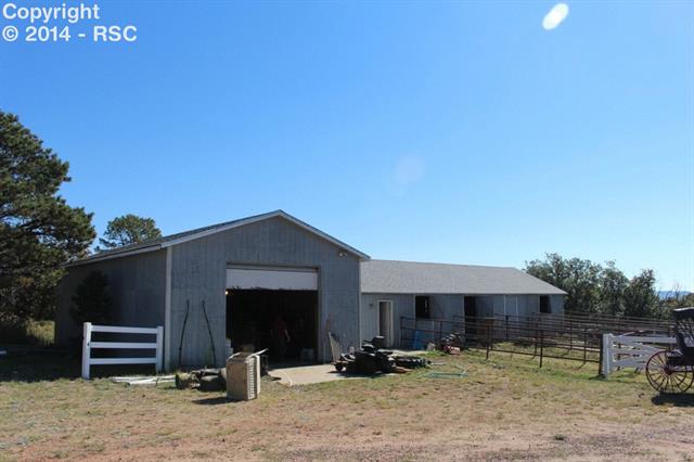 3185 Mt Herman Road Monument, CO 80132 - Photo 6 of 22 Into horses? This barn features 4 individual stalls, storage for your feed, and a 1500' barn/garage with high ceiling.