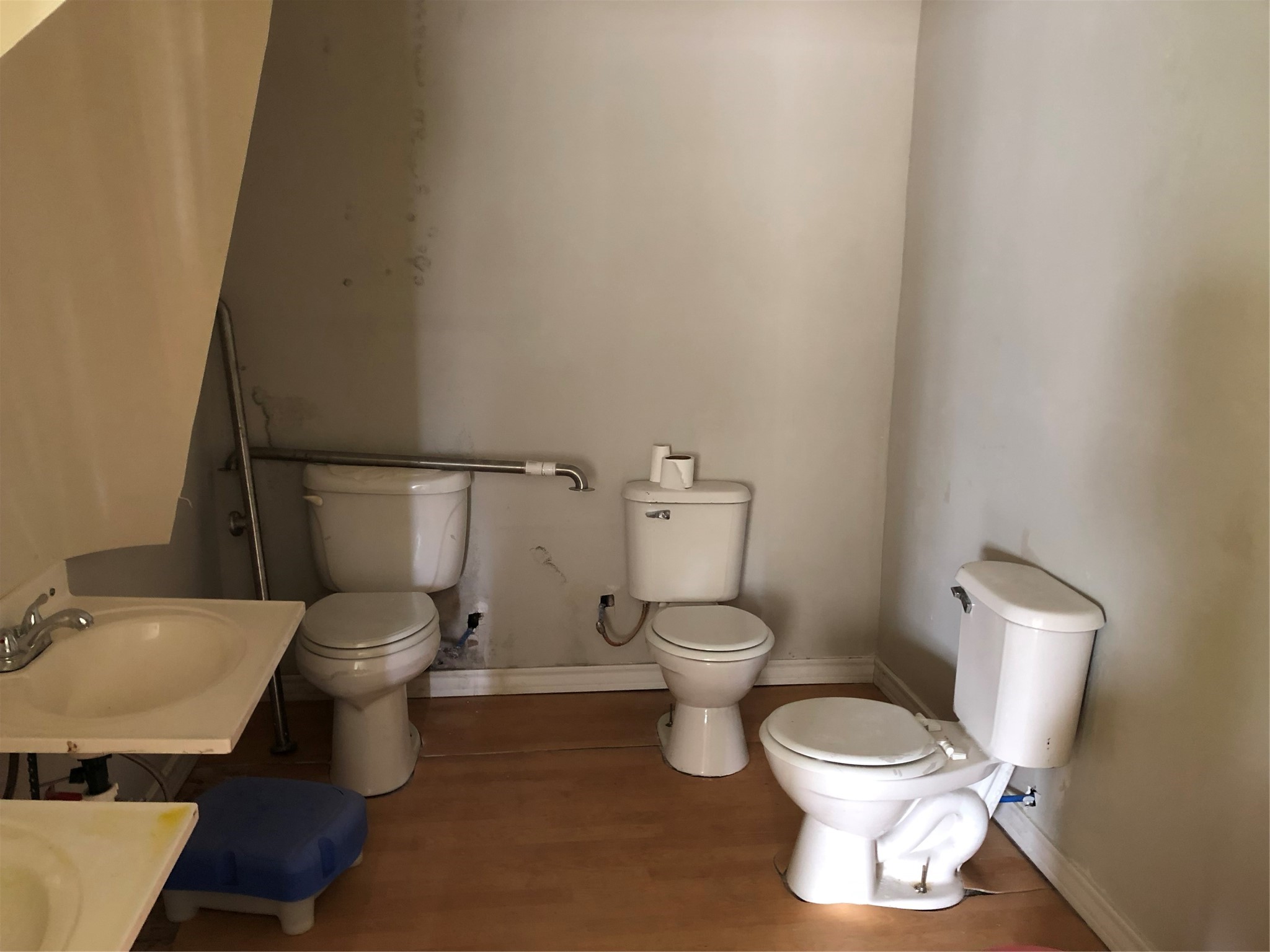 9317 Homestead Road Houston, TX 77016 - Photo 5 of 8 a white toilet sitting next to a bathroom sink and vanity