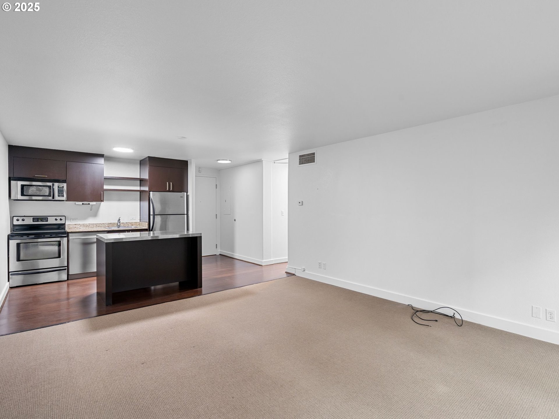255 Southwest Harrison Street, Unit 3C Portland, OR 97201 - Photo 13 of 32 a view of kitchen with refrigerator and microwave