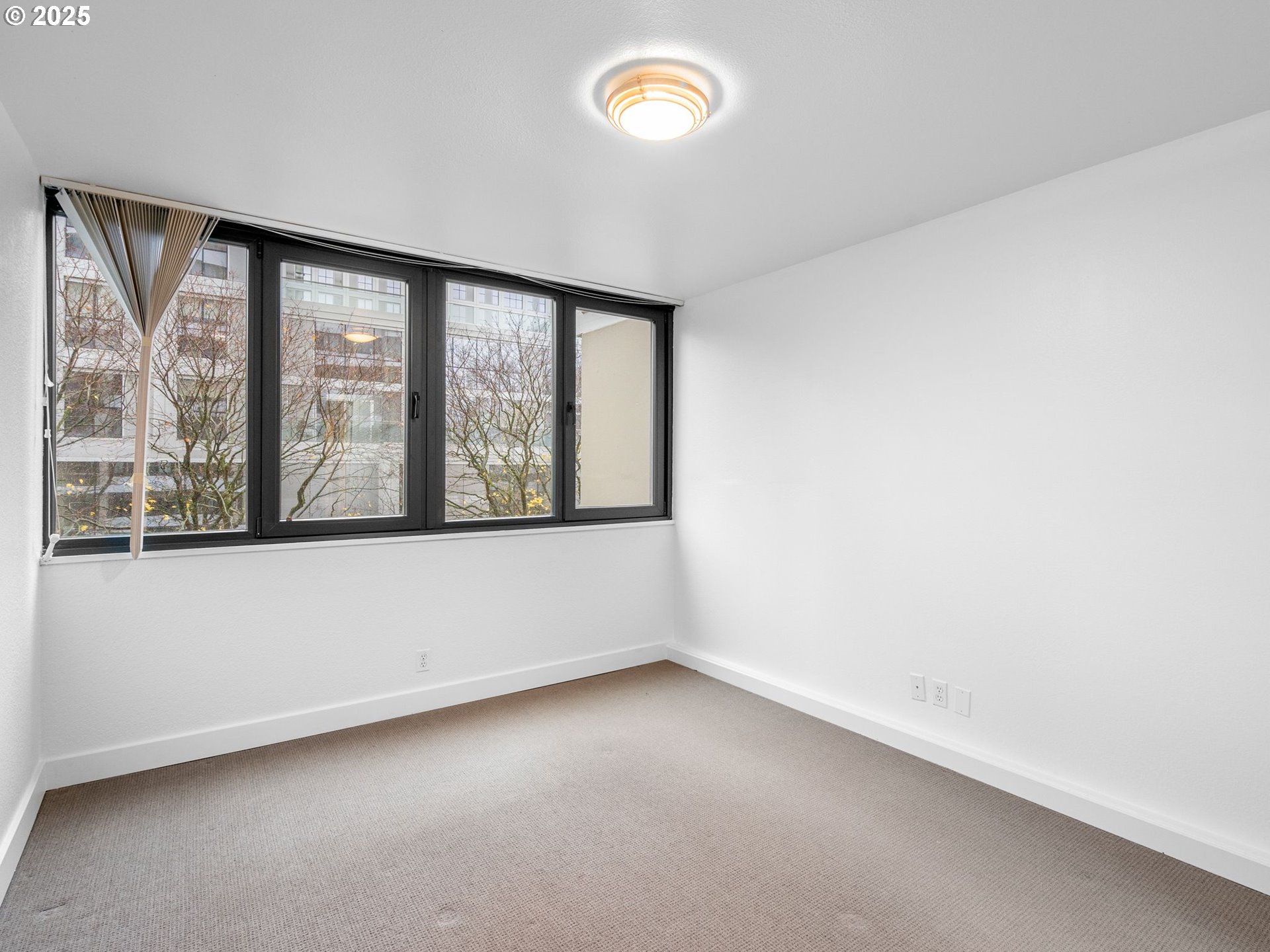 255 Southwest Harrison Street, Unit 3C Portland, OR 97201 - Photo 14 of 32 an empty room with a window
