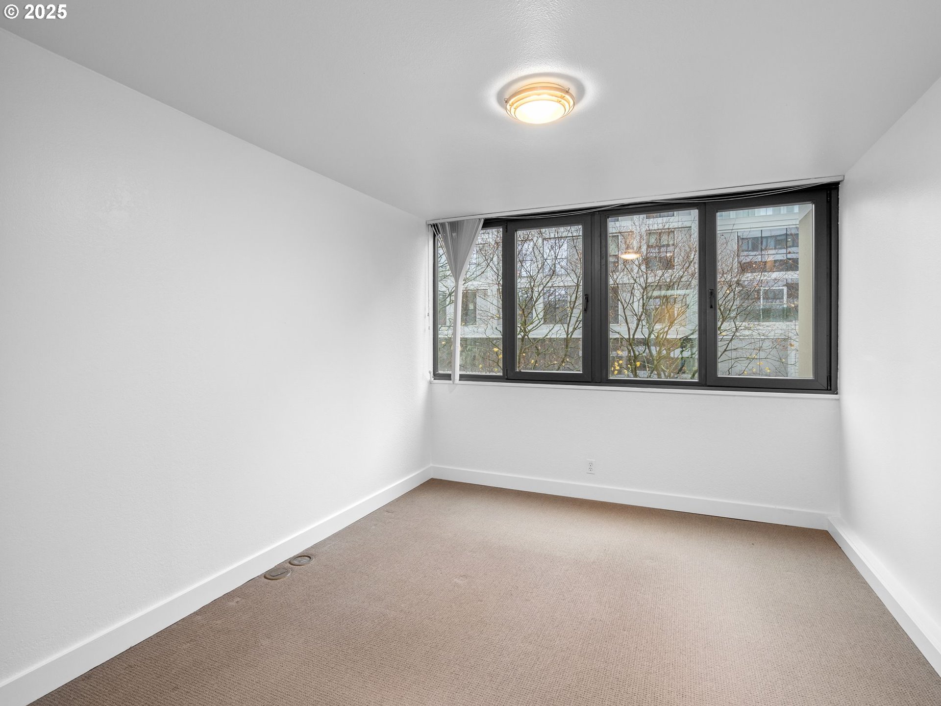 255 Southwest Harrison Street, Unit 3C Portland, OR 97201 - Photo 15 of 32 an empty room with a window