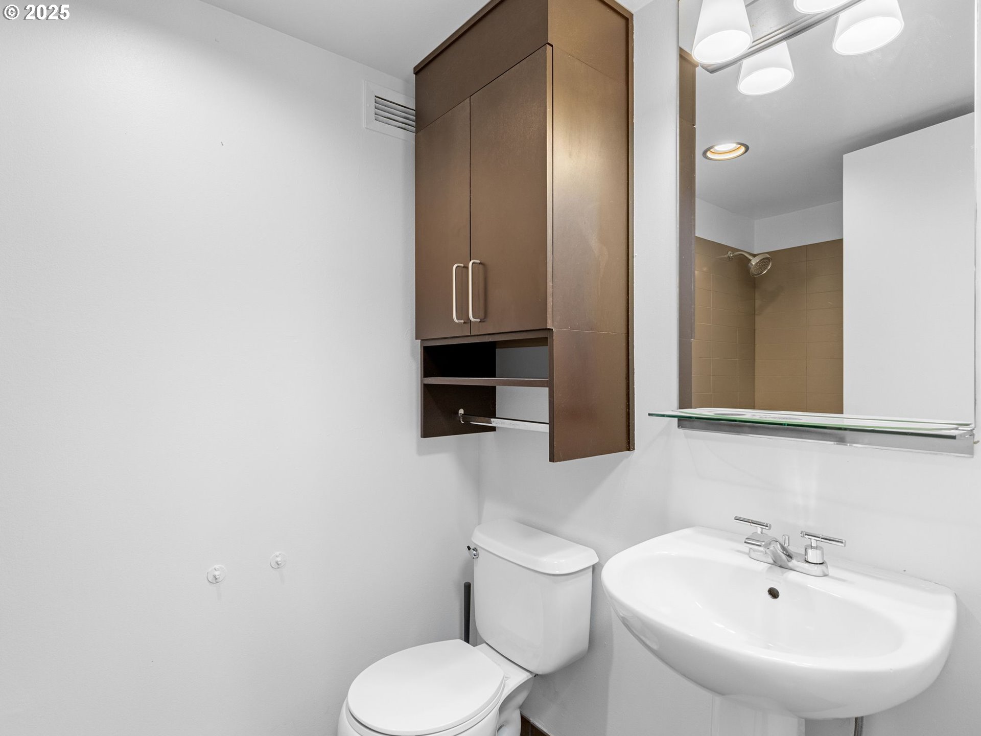255 Southwest Harrison Street, Unit 3C Portland, OR 97201 - Photo 17 of 32 a bathroom with a toilet sink and mirror