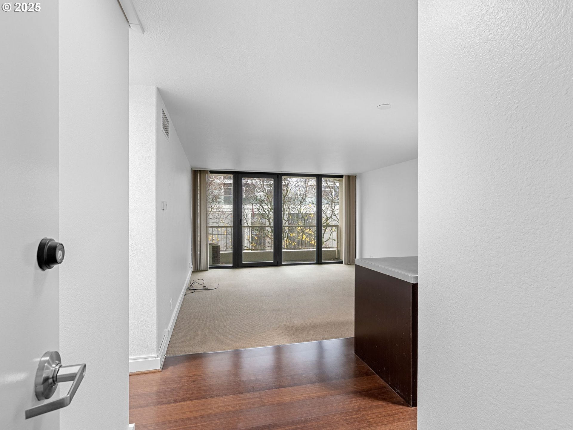 255 Southwest Harrison Street, Unit 3C Portland, OR 97201 - Photo 6 of 32 a view of an empty room with glass door