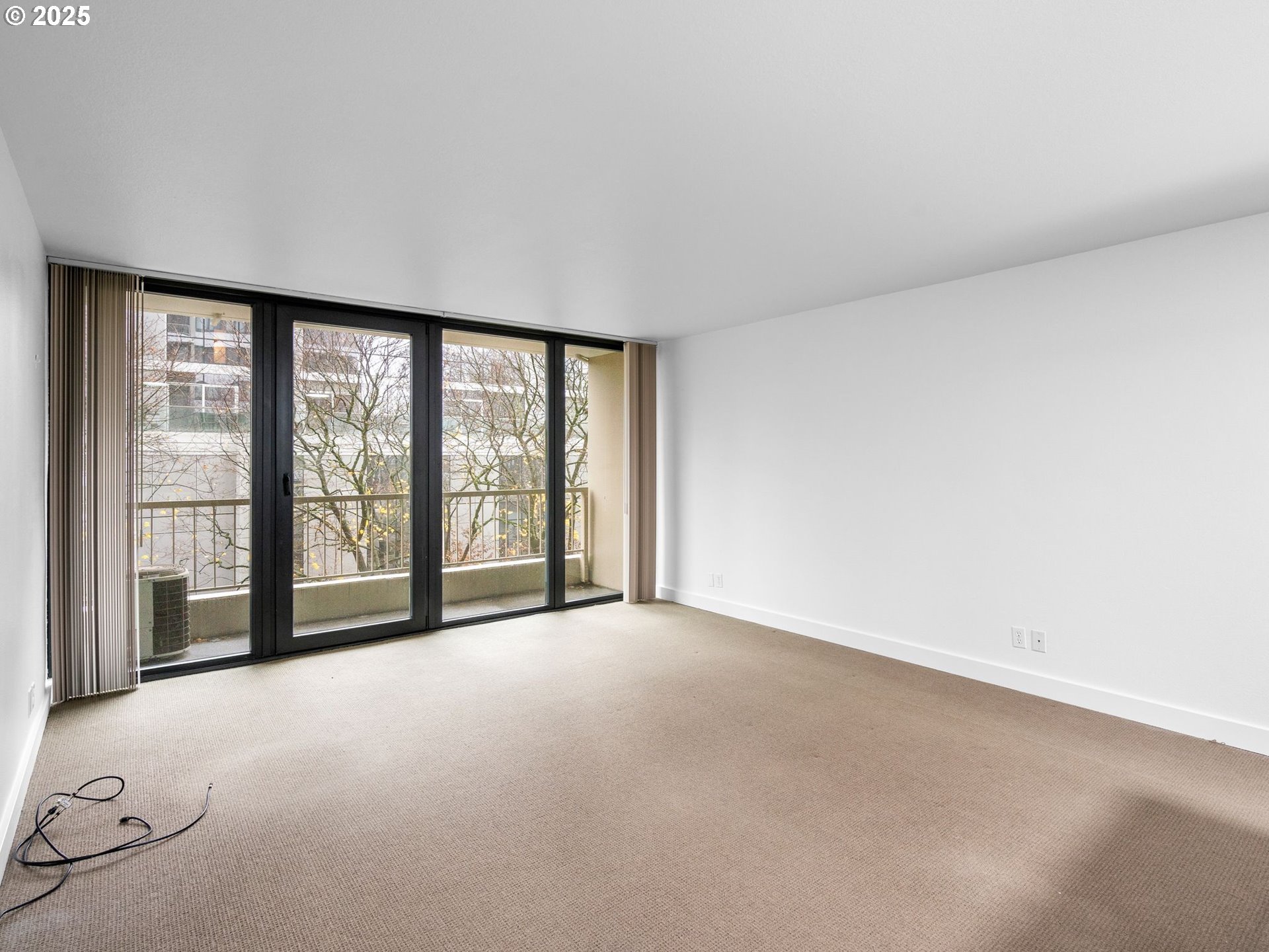 255 Southwest Harrison Street, Unit 3C Portland, OR 97201 - Photo 7 of 32 a view of an empty room with a large window