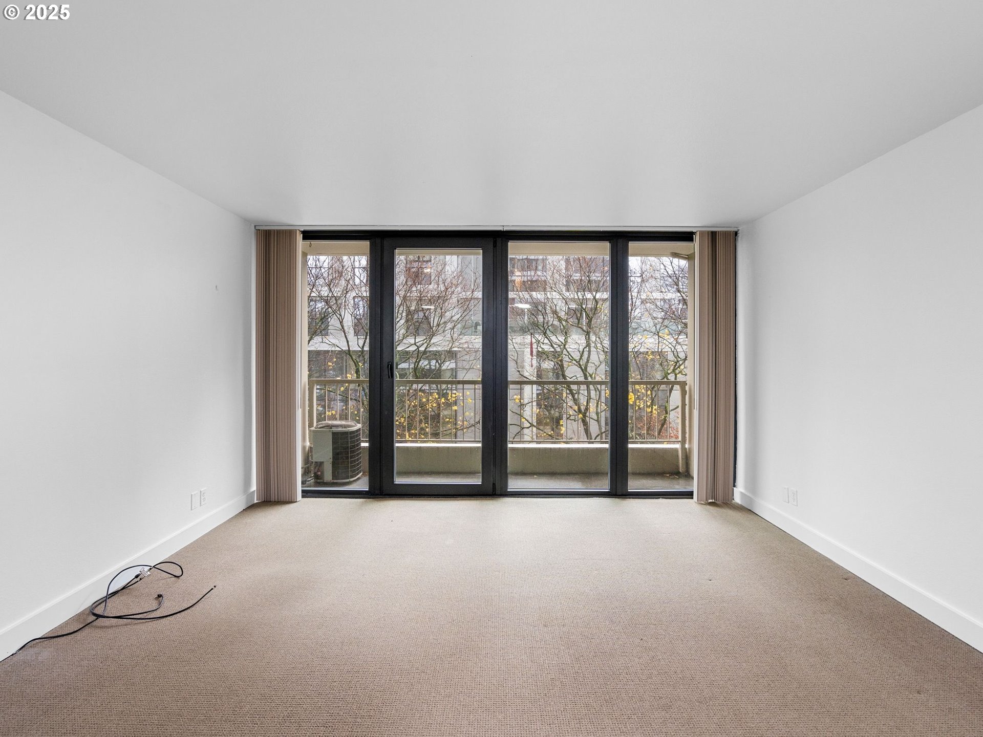 255 Southwest Harrison Street, Unit 3C Portland, OR 97201 - Photo 8 of 32 a view of an empty room with a window