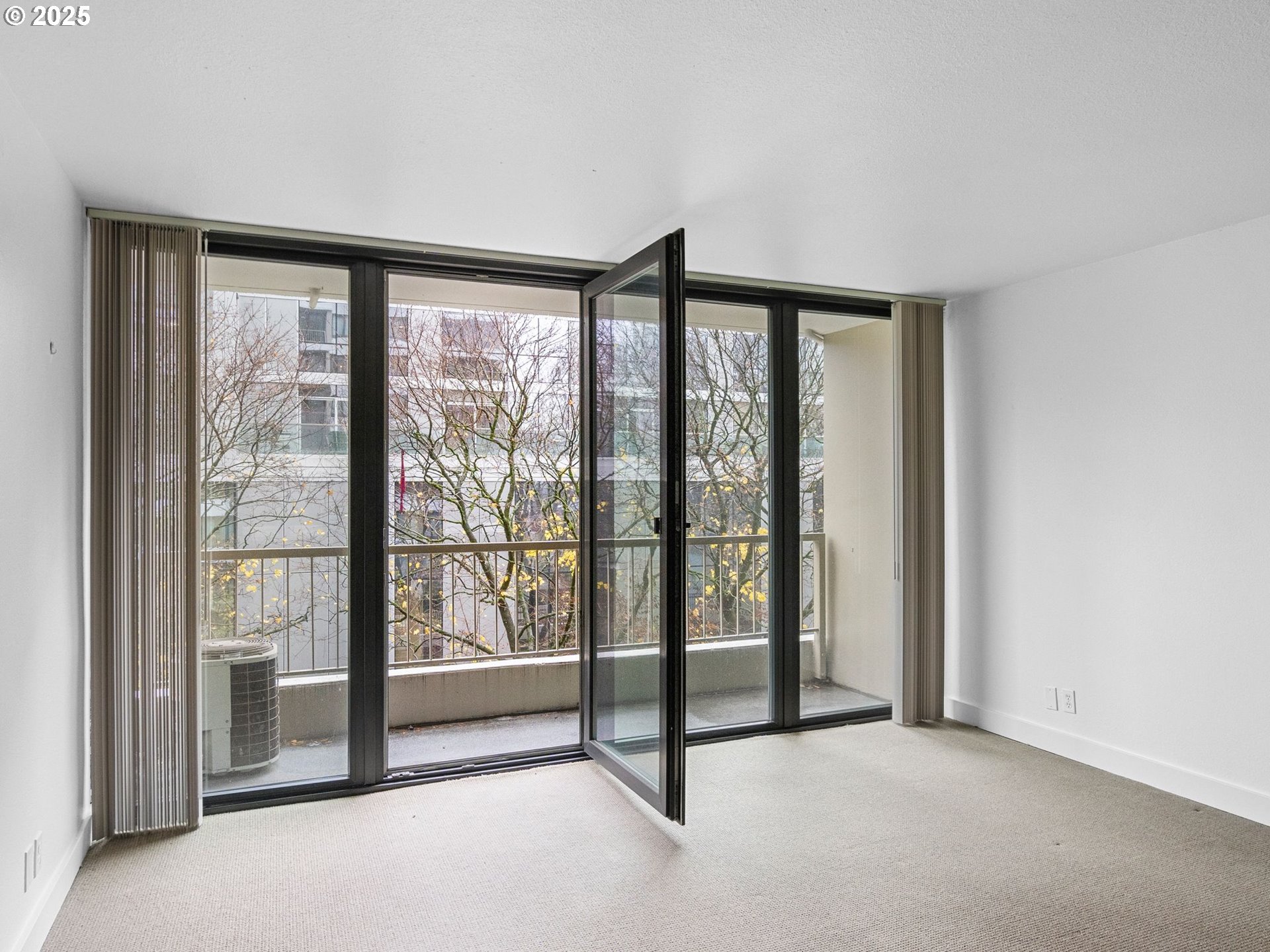 255 Southwest Harrison Street, Unit 3C Portland, OR 97201 - Photo 9 of 32 a view of an empty room with large windows