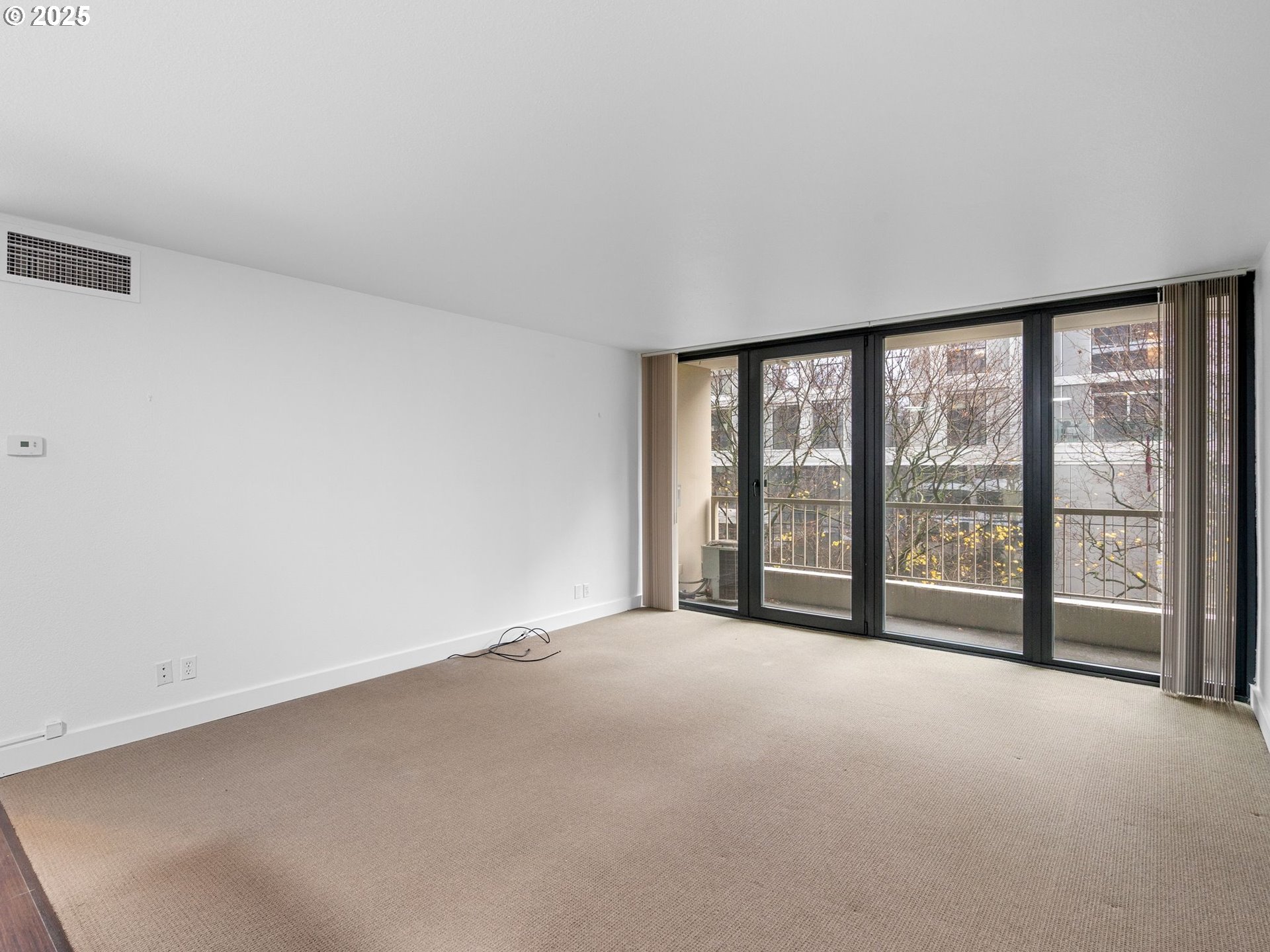 255 Southwest Harrison Street, Unit 3C Portland, OR 97201 - Photo 10 of 32 a view of an empty room with a large window