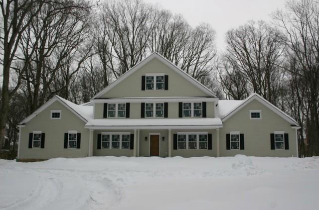 25 Standish Drive Ridgefield, CT 06877 - Photo 1 of 1 a front view of a house with a yard and trees