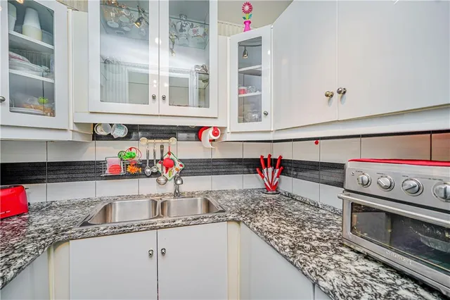 a kitchen with a sink and a stove top oven