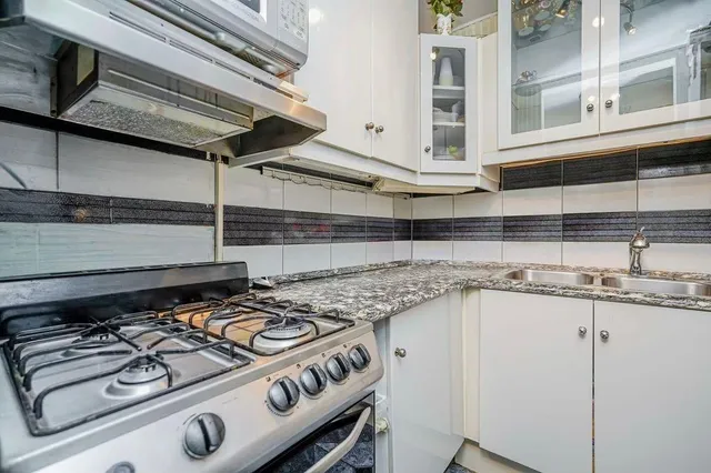 a kitchen with a stove and a sink