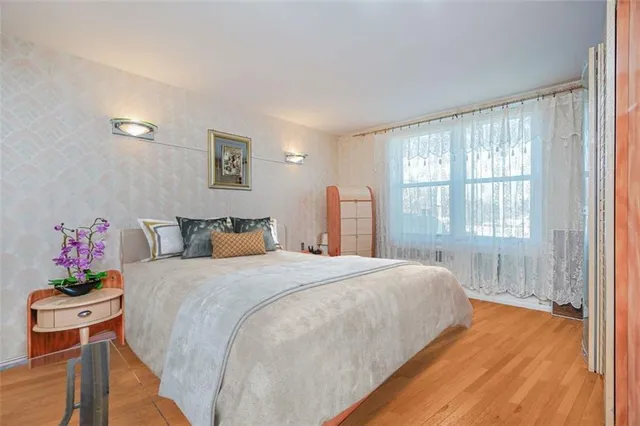 a spacious bedroom with a bed and a window