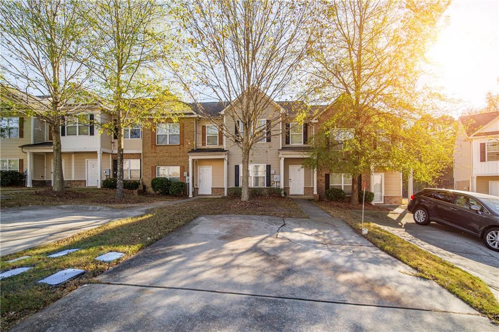 1726 Broad River Road Atlanta, GA 30349 - Photo 1 of 1 a view of a large building with a large tree