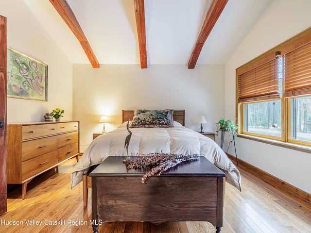 a bed sitting in a bedroom next to a window