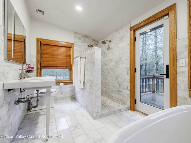 a spacious bathroom with a shower and a sink