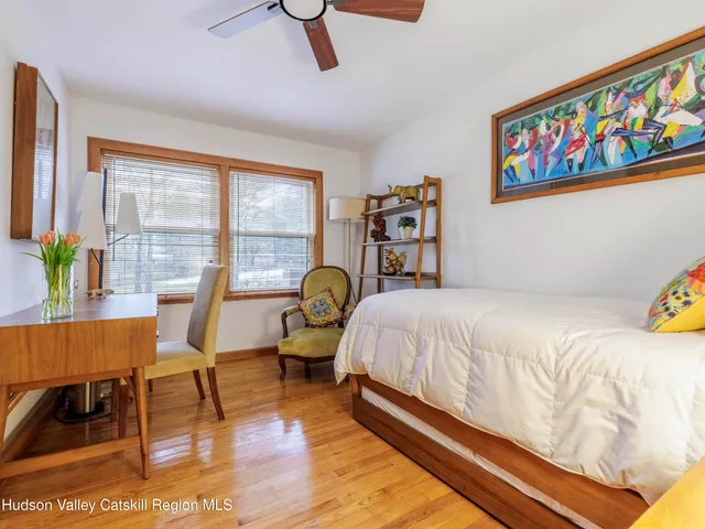 a bedroom with a bed and a large window