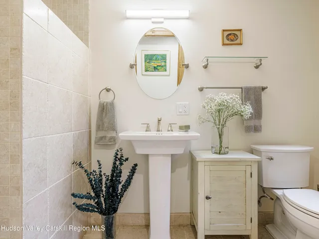 a bathroom with a toilet sink and mirror