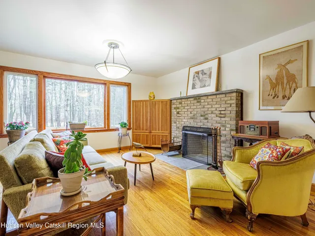 a living room with furniture fireplace and window