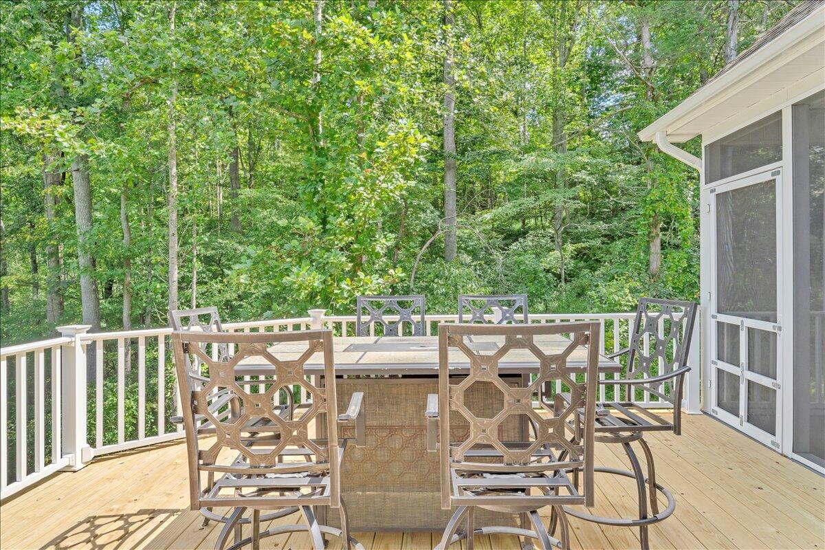 2011 Deep Woods Road Hardy, VA 24101 - Photo 53 of 94 a view of a patio with table and chairs with wooden floor and fence