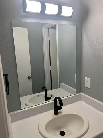 a bathroom with a sink and a mirror
