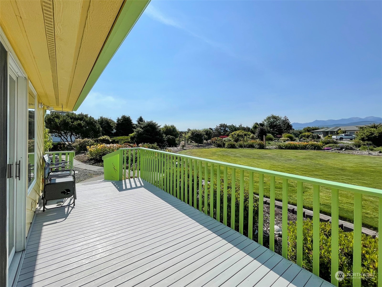 421 Greywolf Road Sequim, WA 98382 - Photo 12 of 40 a view of a deck with wooden floor and fence next to a yard