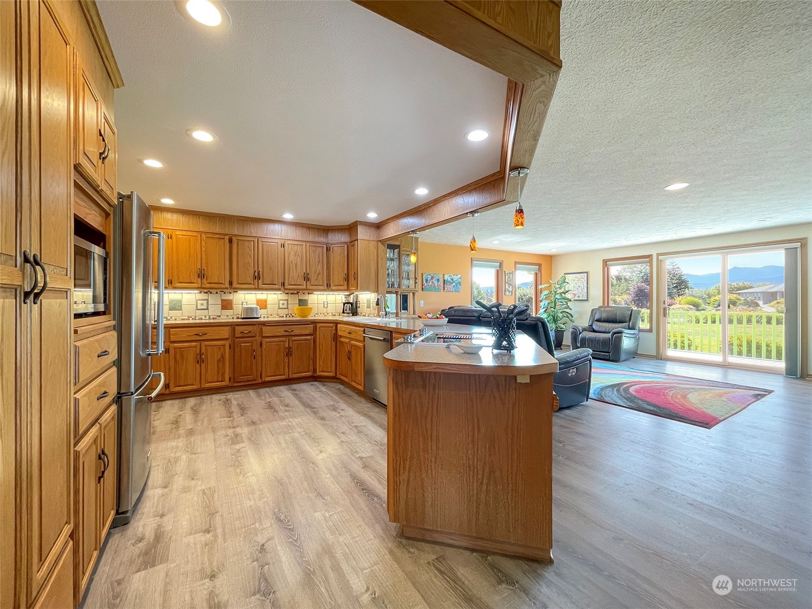421 Greywolf Road Sequim, WA 98382 - Photo 13 of 40 a kitchen with stainless steel appliances granite countertop a stove and cabinets