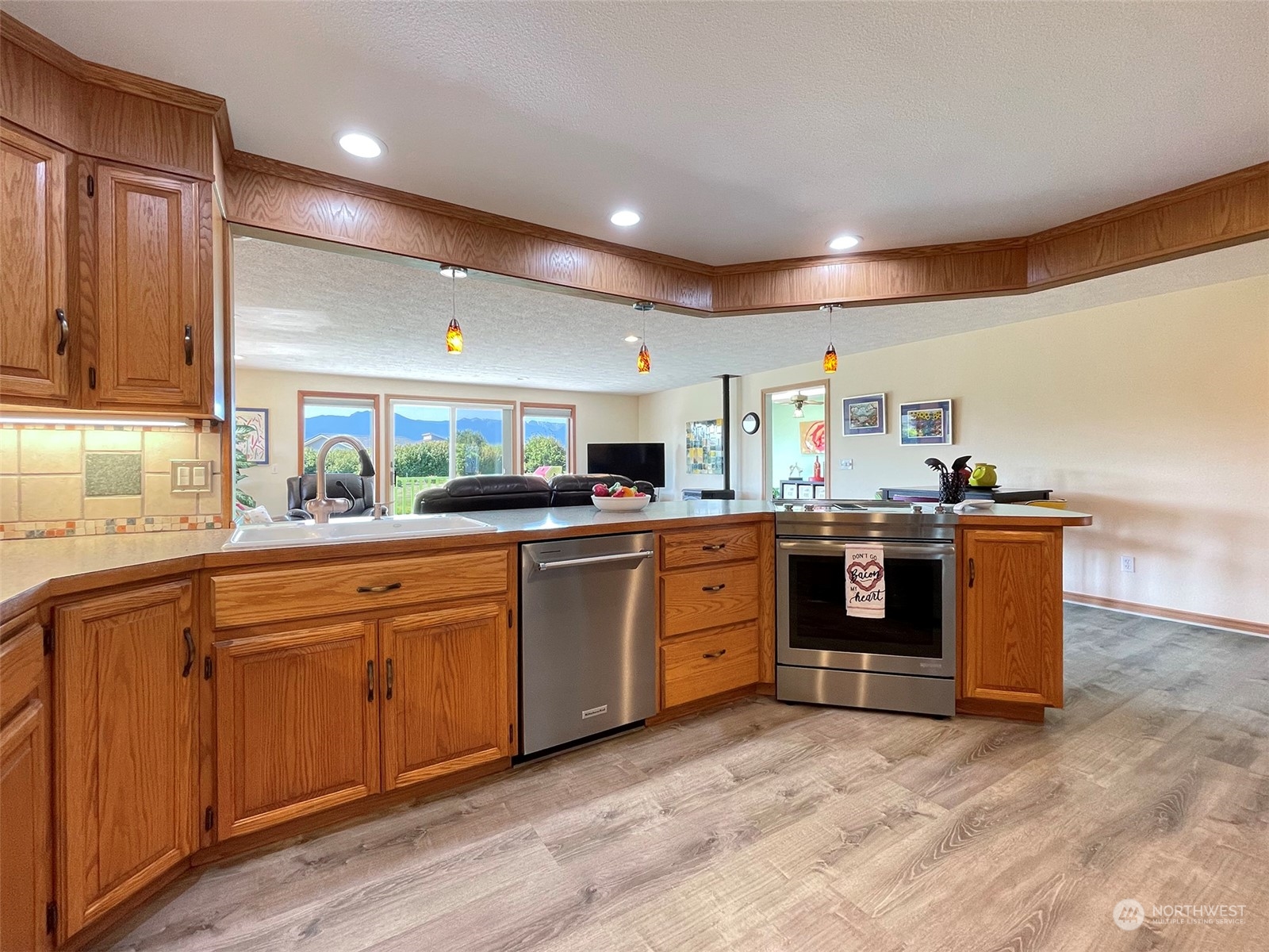 421 Greywolf Road Sequim, WA 98382 - Photo 15 of 40 a kitchen with stainless steel appliances granite countertop a sink and cabinets