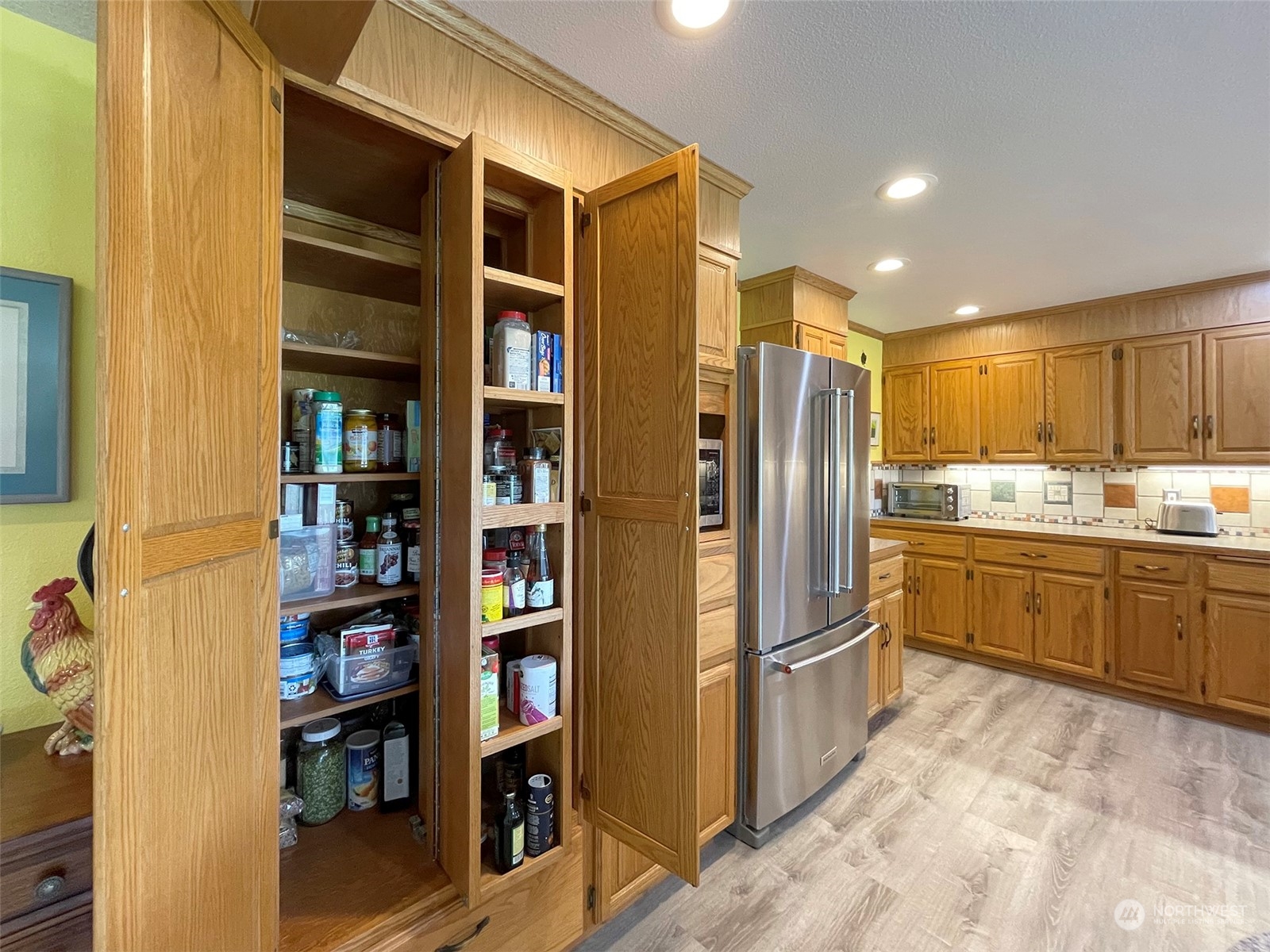 421 Greywolf Road Sequim, WA 98382 - Photo 16 of 40 a kitchen with stainless steel appliances granite countertop a refrigerator and a sink