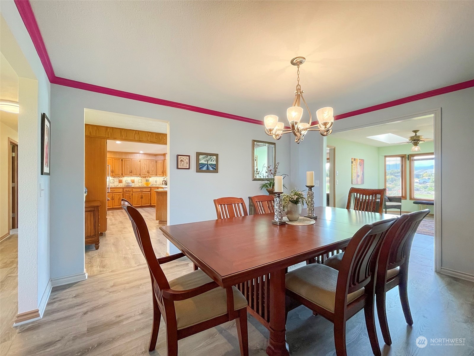 421 Greywolf Road Sequim, WA 98382 - Photo 19 of 40 a dining room with furniture a chandelier and wooden floor