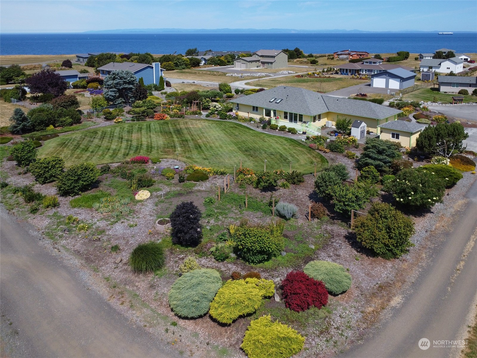 421 Greywolf Road Sequim, WA 98382 - Photo 3 of 40 an aerial view of residential houses with outdoor space and trees