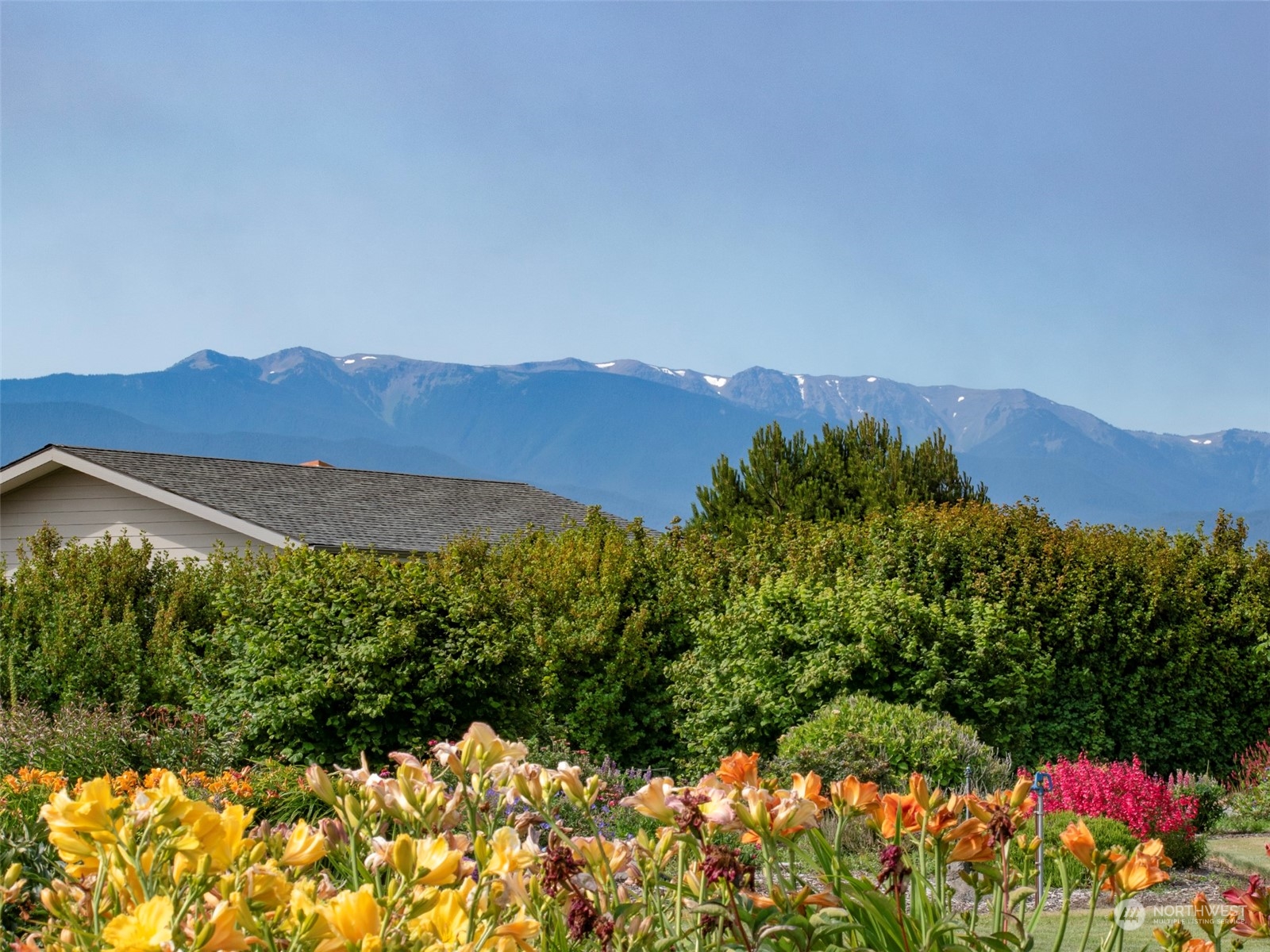 421 Greywolf Road Sequim, WA 98382 - Photo 36 of 40 a view of a lake with a mountain in the background