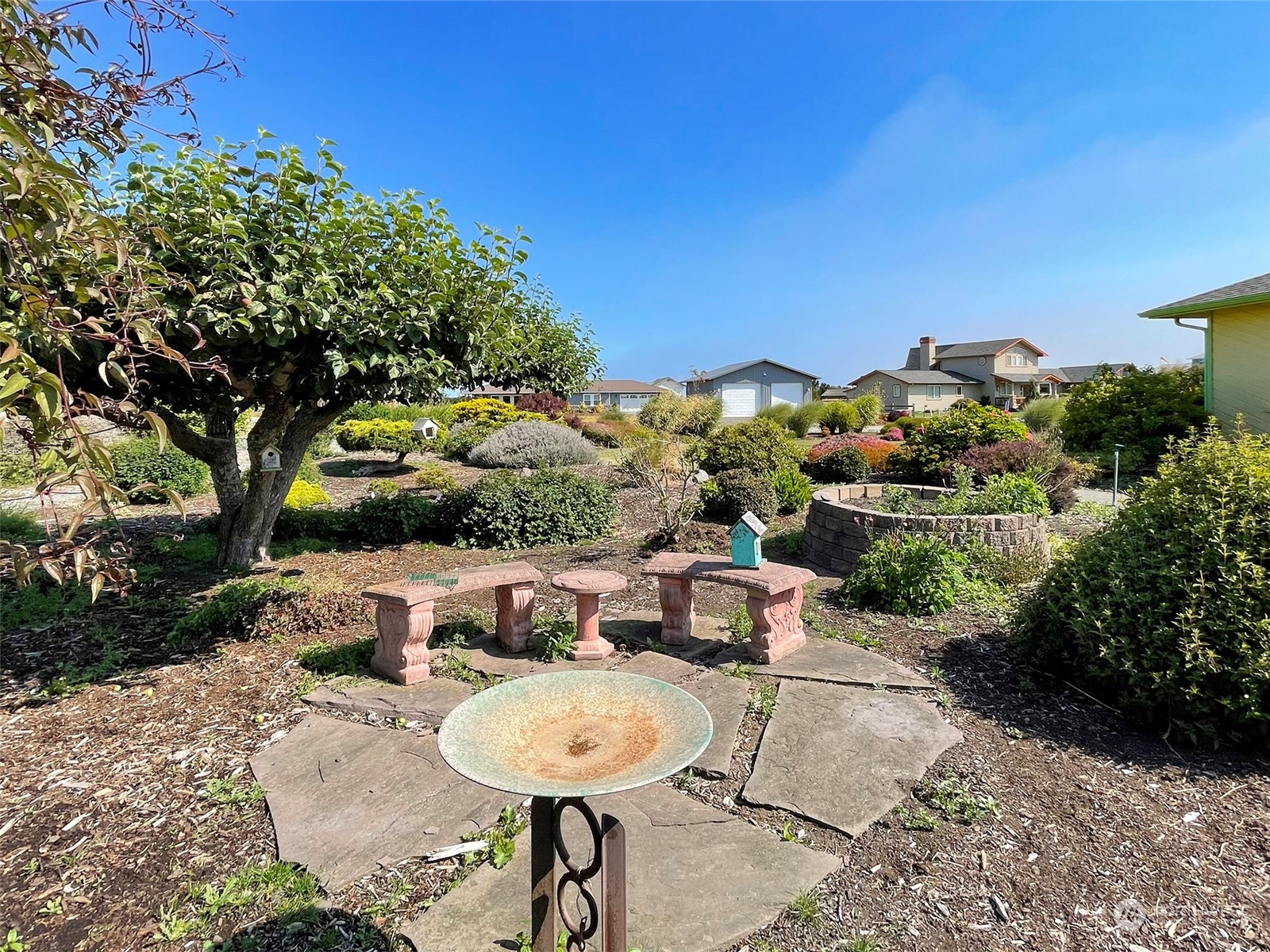 421 Greywolf Road Sequim, WA 98382 - Photo 37 of 40 a view of a backyard with table and chairs and potted plants