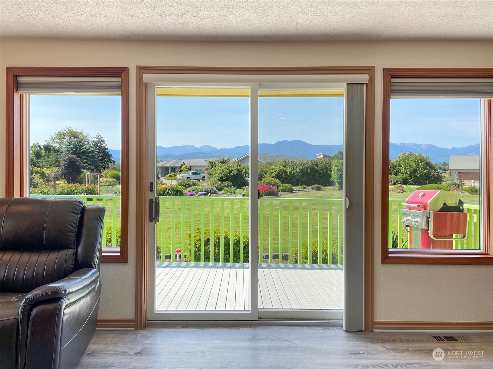 421 Greywolf Road Sequim, WA 98382 - Photo 8 of 40 a view of an empty room with wooden floor and a floor to ceiling window