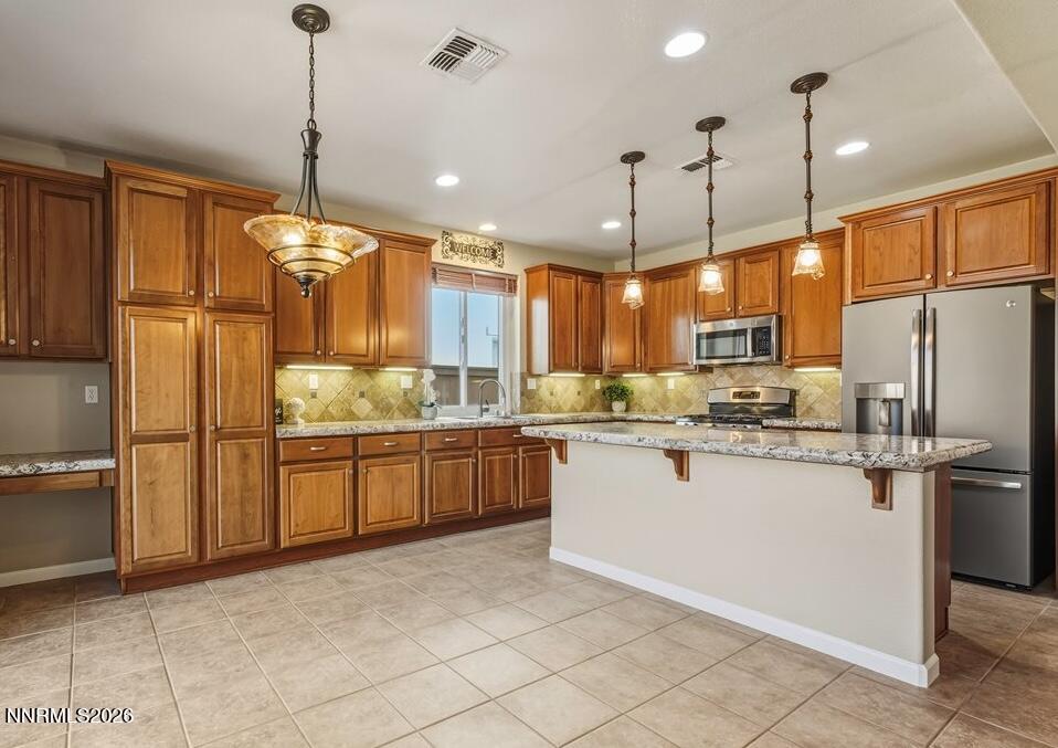 a kitchen with a refrigerator a sink and cabinets