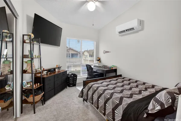a bedroom with a bed and a flat screen tv