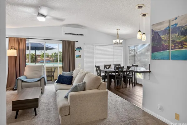 a living room with furniture a table and chairs